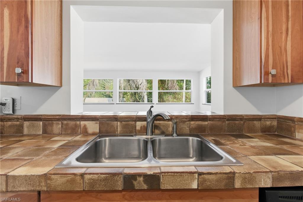 1235 Rordon Avenue Naples, FL 34103 - Photo 10 of 50 a kitchen with a sink and a window