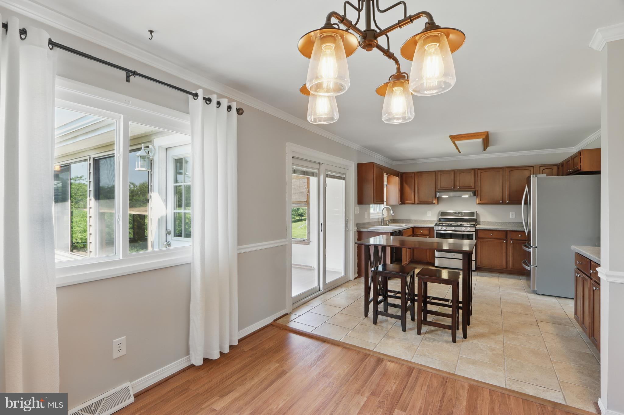 13228 Jesse Smith Road Mount Airy, MD 21771 - Photo 15 of 47 a view of a dining room with furniture wooden floor and chandelier