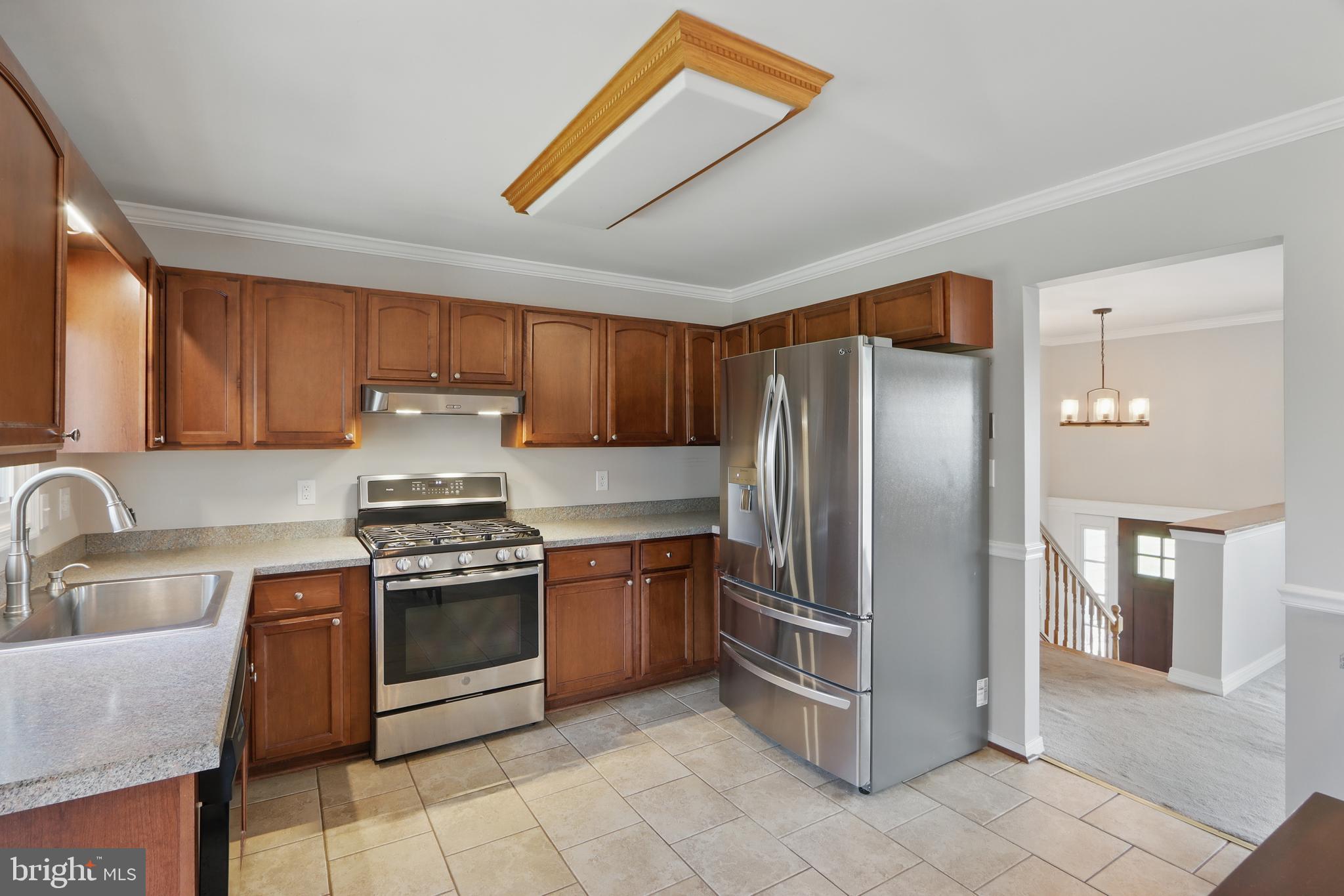 13228 Jesse Smith Road Mount Airy, MD 21771 - Photo 18 of 47 a kitchen with stainless steel appliances granite countertop a stove a sink dishwasher and a refrigerator