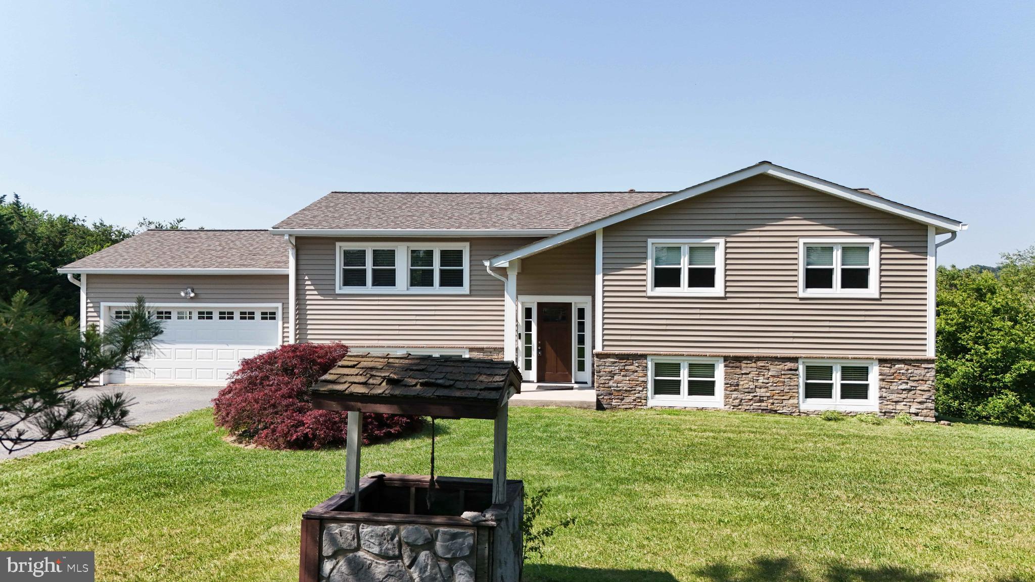 13228 Jesse Smith Road Mount Airy, MD 21771 - Photo 2 of 47 a front view of house with a garden and patio