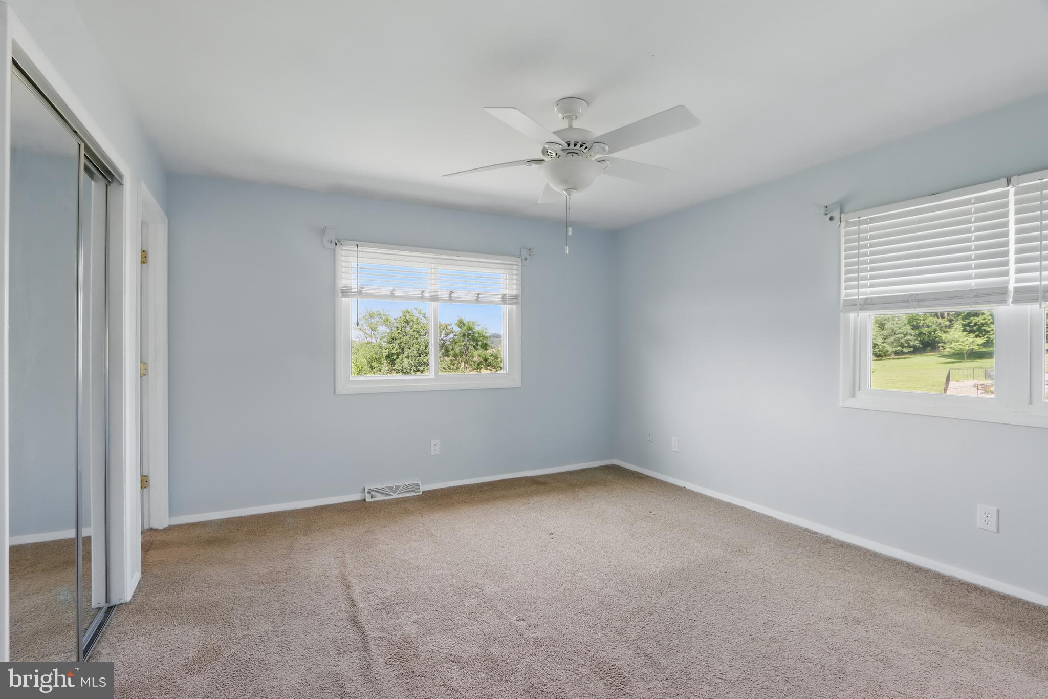 13228 Jesse Smith Road Mount Airy, MD 21771 - Photo 23 of 47 an empty room with windows and fan