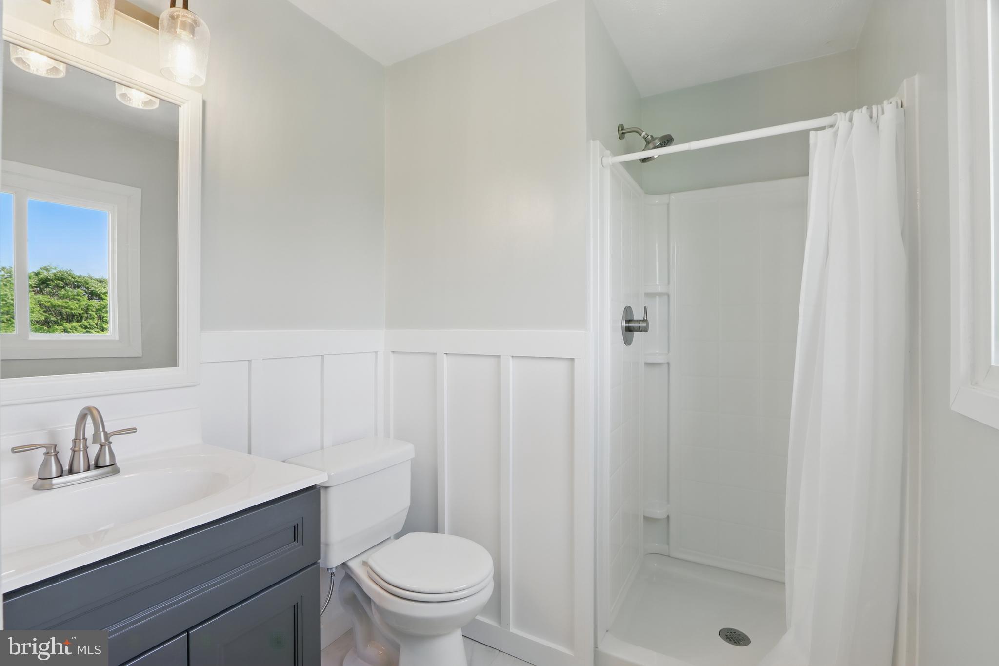 13228 Jesse Smith Road Mount Airy, MD 21771 - Photo 25 of 47 a bathroom with a sink vanity mirror and toilet