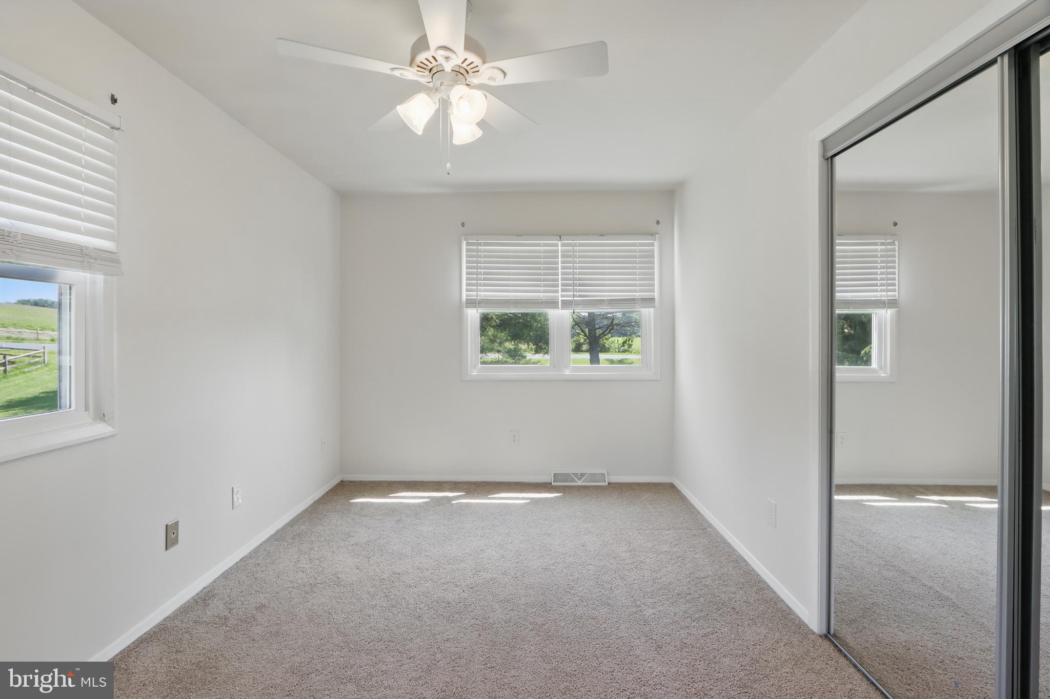 13228 Jesse Smith Road Mount Airy, MD 21771 - Photo 26 of 47 an empty room with a window and a fan