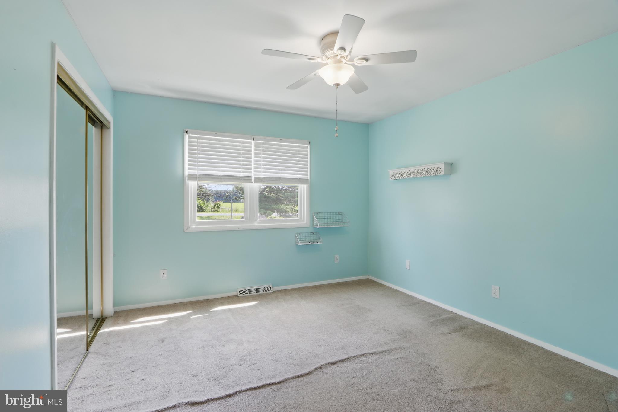 13228 Jesse Smith Road Mount Airy, MD 21771 - Photo 28 of 47 an empty room with a window and a ceiling fan