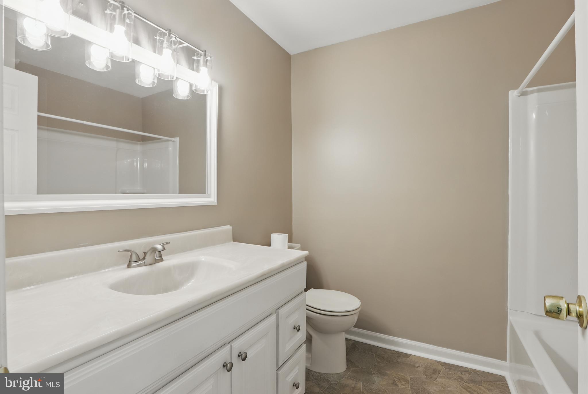 13228 Jesse Smith Road Mount Airy, MD 21771 - Photo 30 of 47 a bathroom with a sink toilet and a mirror