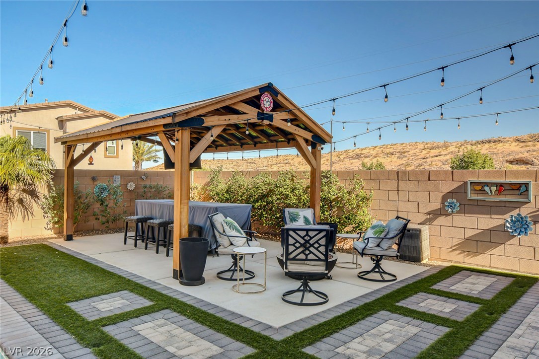 9688 Rankin Rdg Court Las Vegas, NV 89178 - Photo 46 of 53 A private outdoor space with a charming covered patio and string lights for evening gatherings.