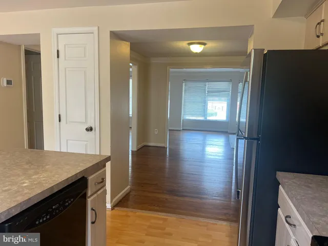 a view of hallway with wooden floor