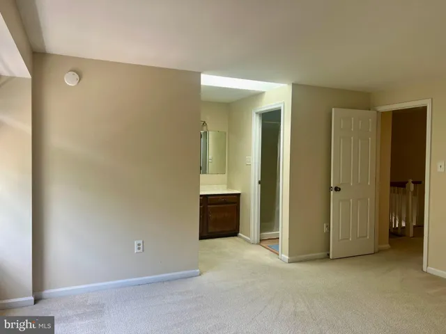 an empty room with closet and a bathroom