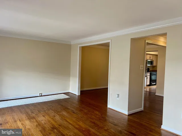 an empty room with wooden floor and closet