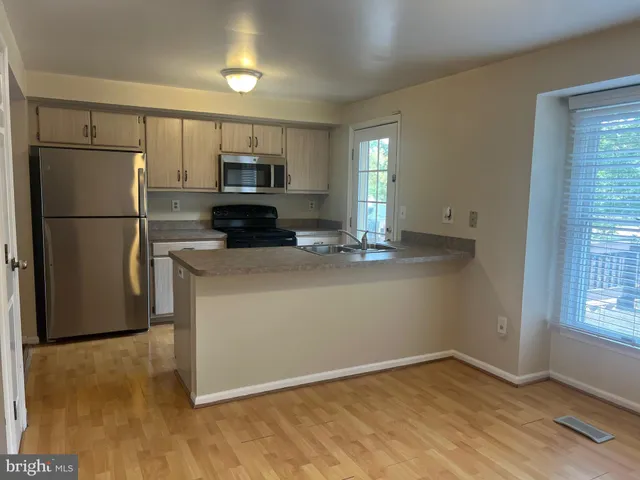 a kitchen with a refrigerator sink and microwave