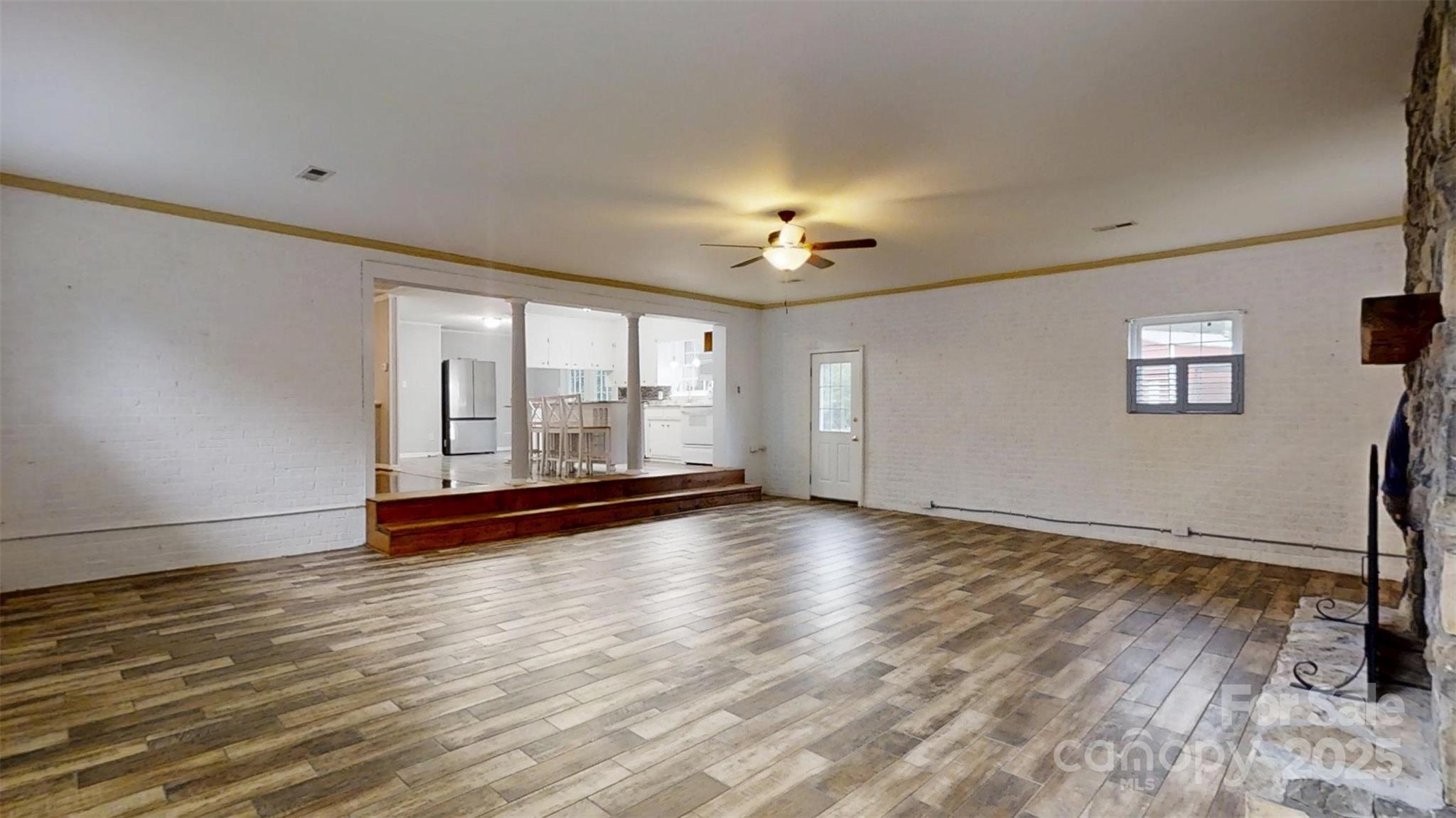 3151 Lynn Mountain Road Vale, NC 28168 - Photo 17 of 38 a view of an empty room with a window and wooden floor
