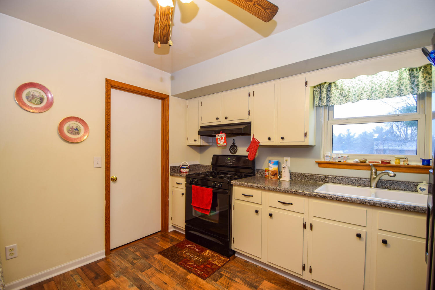 544 Olney Road Vinton, VA 24179 - Photo 8 of 23 a kitchen with granite countertop a sink cabinets stainless steel appliances and a window