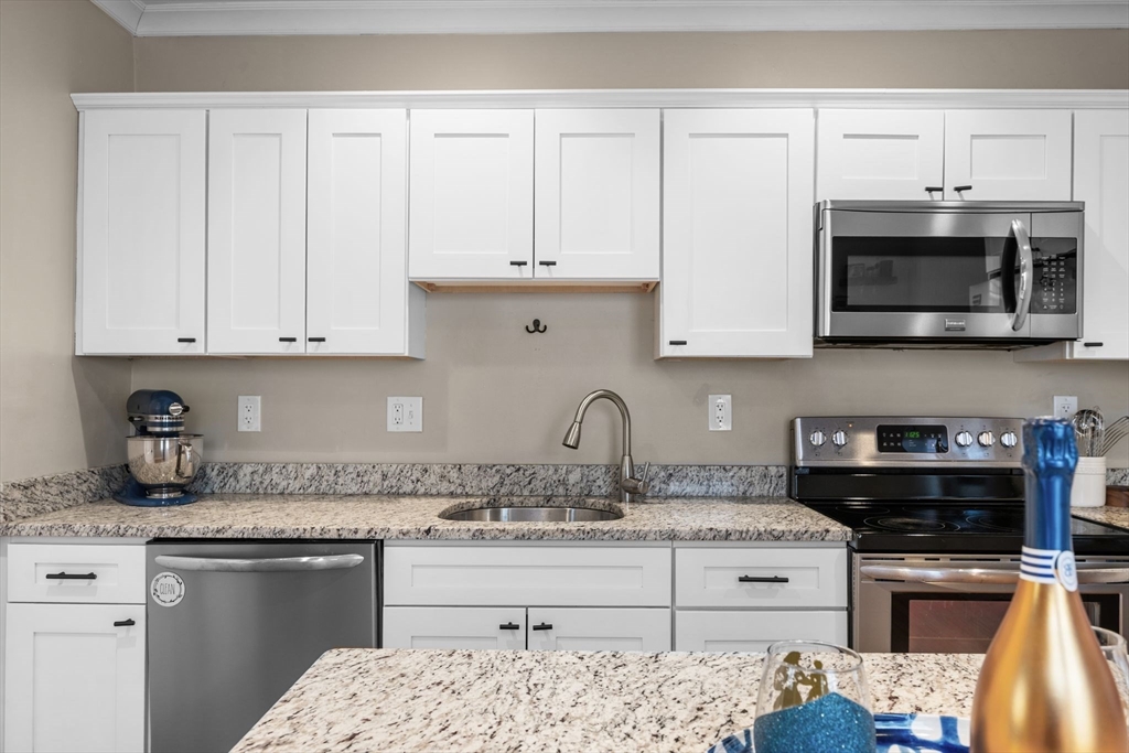 34 Moffatt Road, Unit 34 Salem, MA 01970 - Photo 5 of 23 a kitchen with granite countertop white cabinets and stainless steel appliances