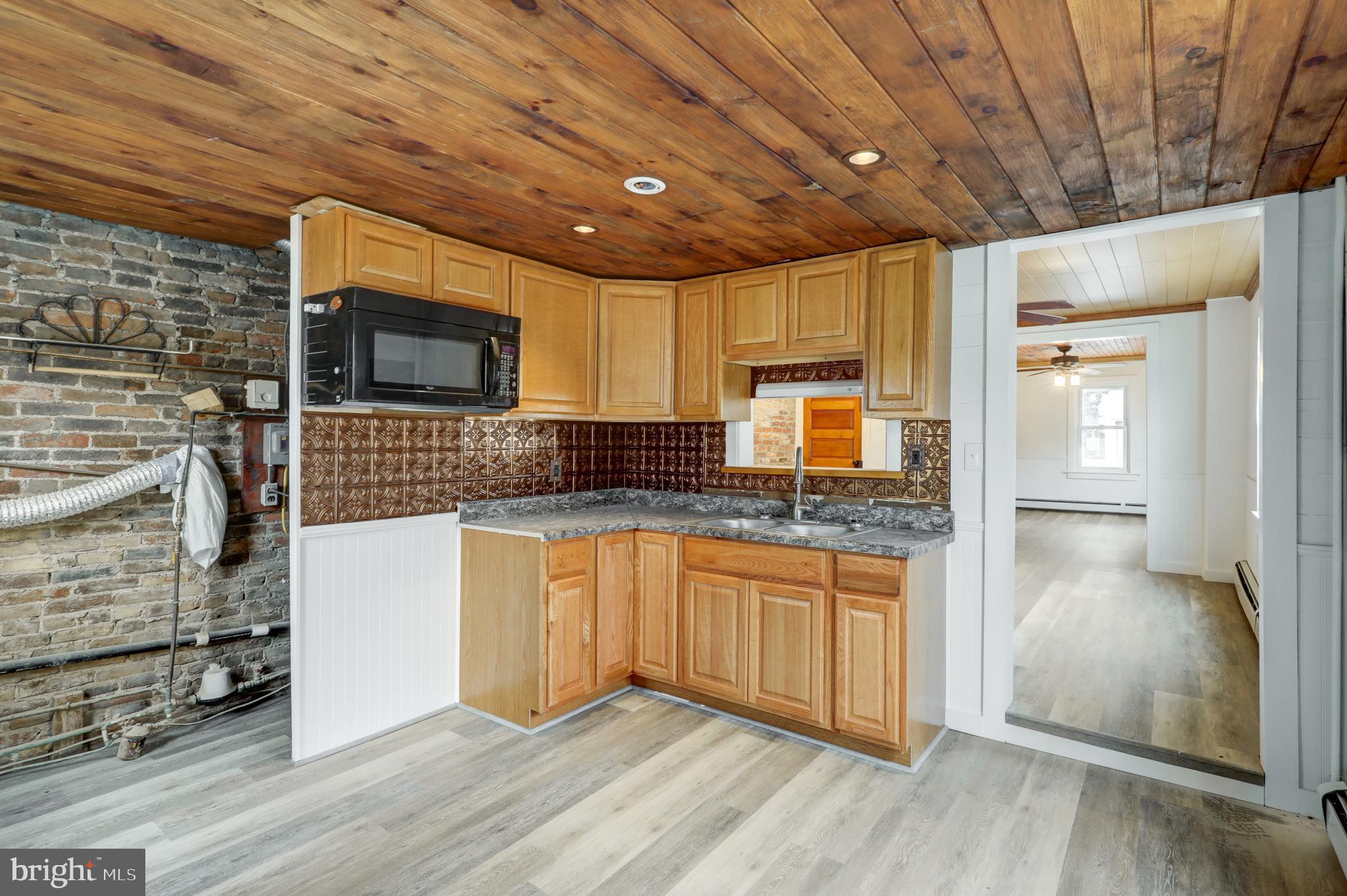157 South Wolf Street Manheim, PA 17545 - Photo 14 of 23 a kitchen with stainless steel appliances granite countertop a stove a sink and a microwave