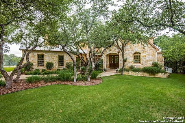 a front view of a house with a garden and yard