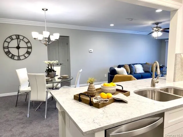 a view of a dining room with furniture and chandelier