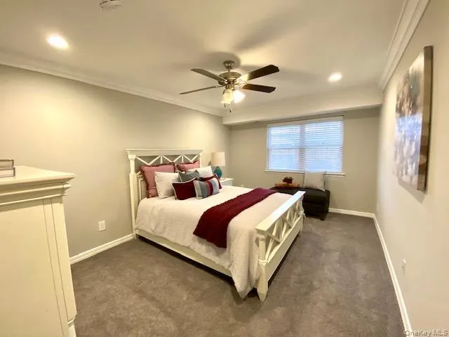 a spacious bedroom with a bed and a chandelier