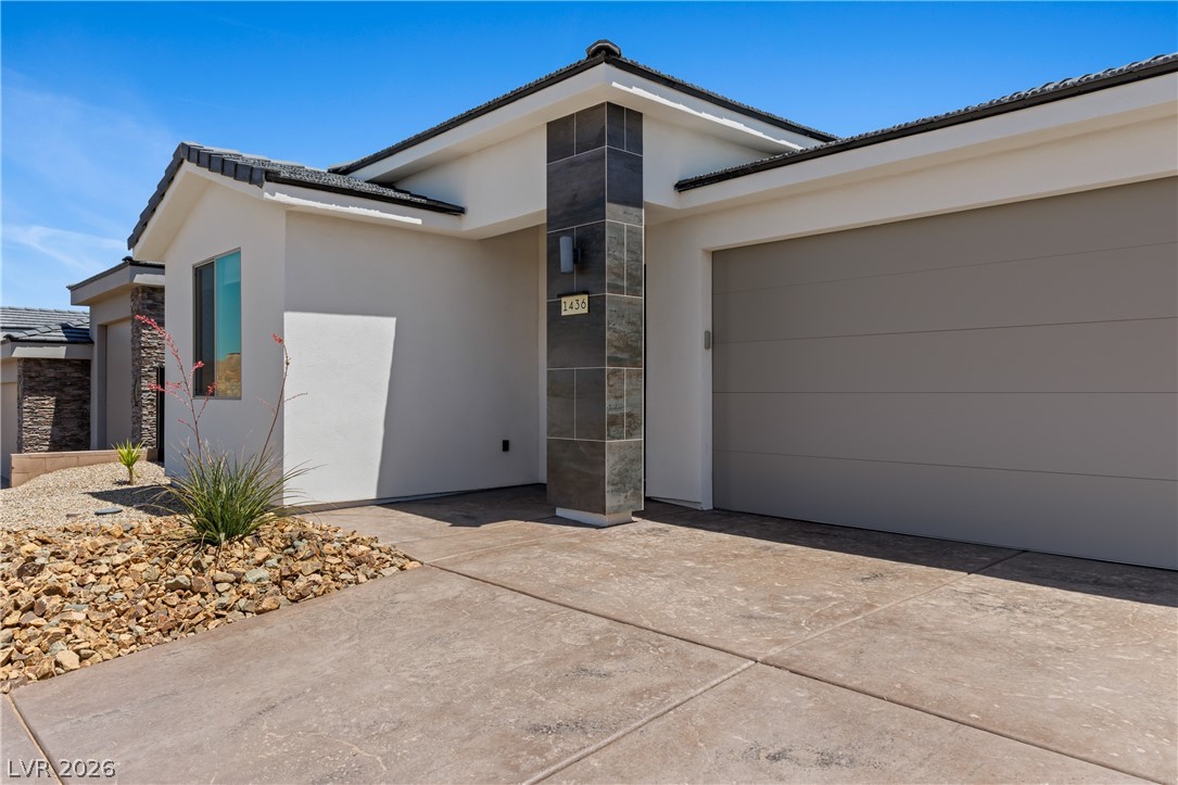 1436 Manassas Ridge Mesquite, NV 89027 - Photo 65 of 77 A contemporary facade greets visitors with a tiled entry column and an integrated garage.