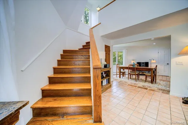 a view of a hallway with wooden floor and a potted plant