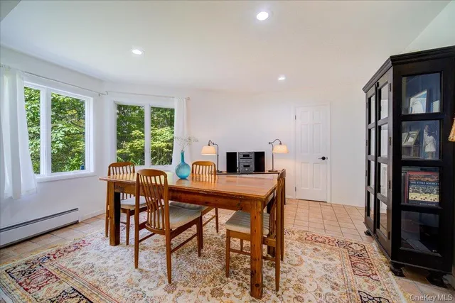 a dining room with furniture and window