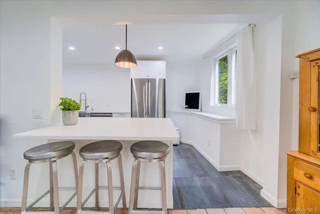 a large white kitchen with a large window