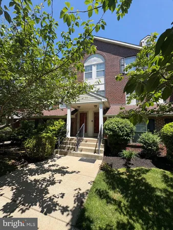 a front view of a house with yard and green space