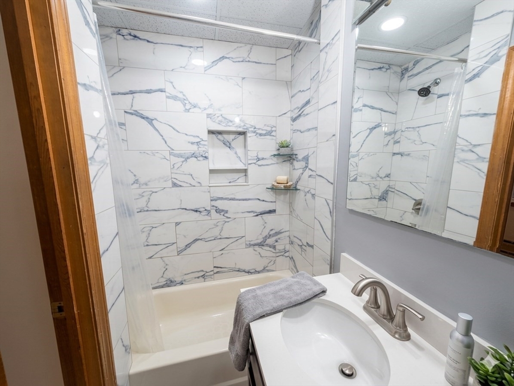 22 Battery Street, Unit 1R Boston, MA 02109 - Photo 7 of 8 a bathroom with a sink and shower