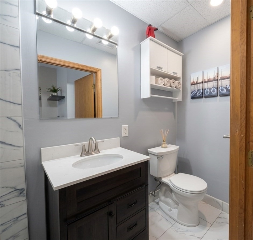 22 Battery Street, Unit 1R Boston, MA 02109 - Photo 8 of 8 a bathroom with a toilet a sink and mirror