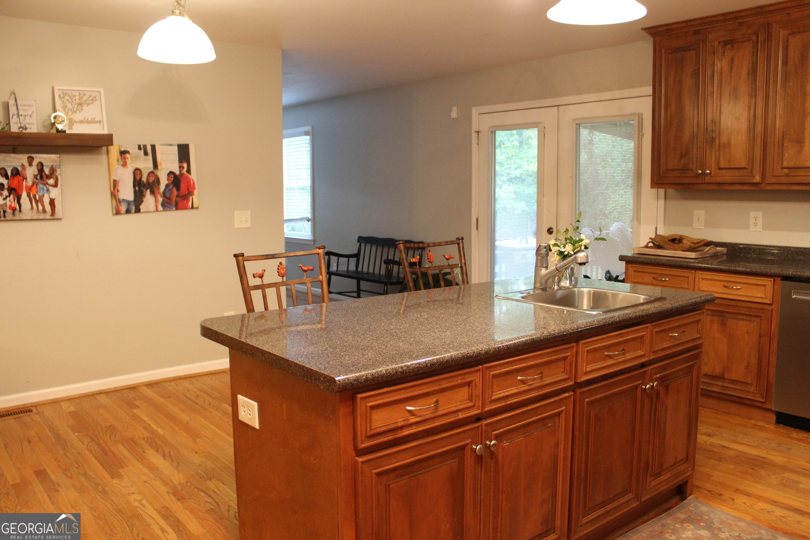 2796 Barbon Road Monroe, GA 30656 - Photo 18 of 36 a kitchen with stainless steel appliances granite countertop a sink dishwasher and cabinets with wooden floor