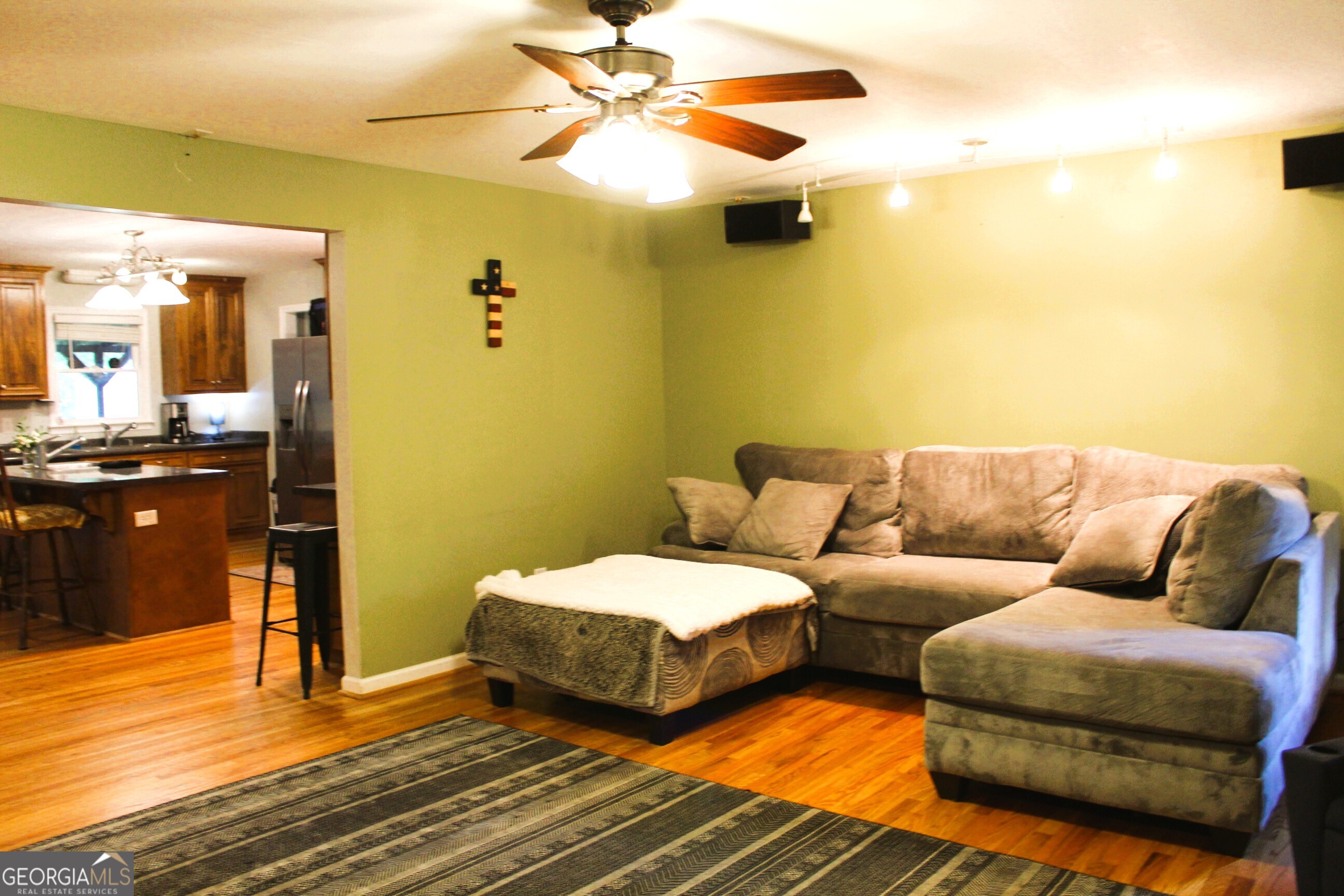 2796 Barbon Road Monroe, GA 30656 - Photo 26 of 36 a living room with a bed and a chandelier