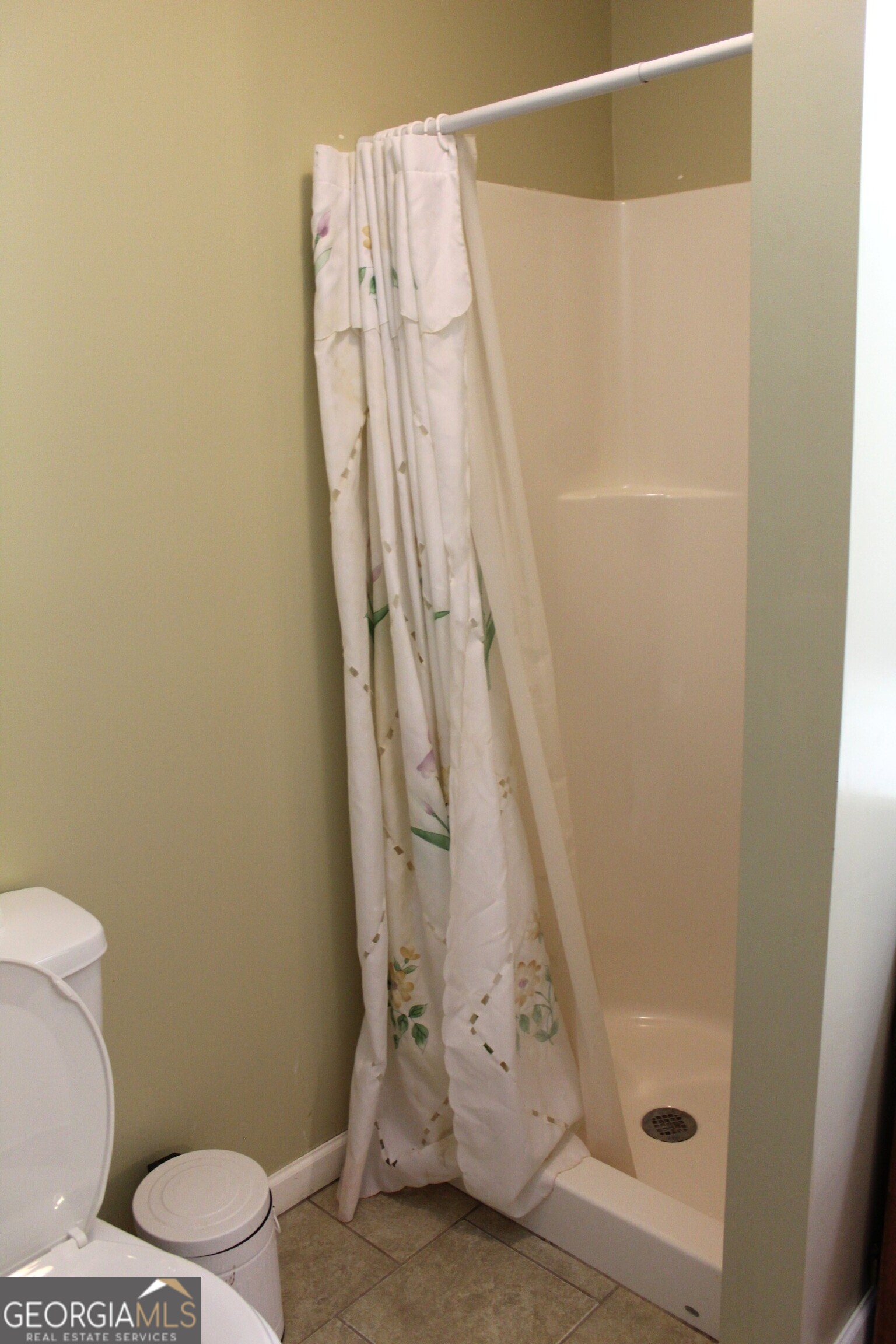 2796 Barbon Road Monroe, GA 30656 - Photo 31 of 36 a bathroom with a shower curtain and a toilet