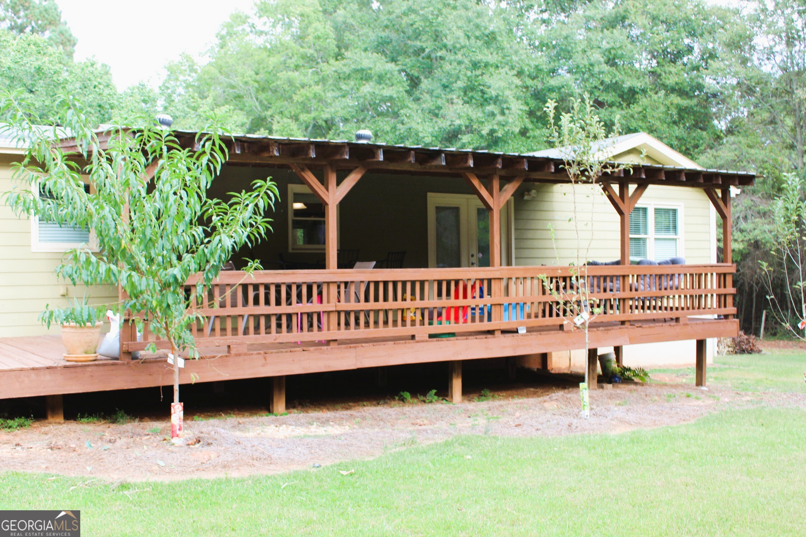 2796 Barbon Road Monroe, GA 30656 - Photo 5 of 36 a view of a deck with a bench