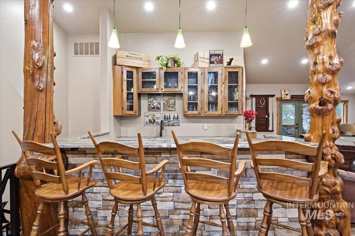 1029 Cee Way Loop McCall, ID 83638 - Photo 26 of 50 Vaulted ceiling with exposed wood beams, skylight, recessed lighting, wood-finish flooring, and natural wood trim throughout