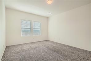 700 Mallow Road Leander, TX 78641 - Photo 17 of 28 Plush carpeting and large windows create a comfortable and inviting atmosphere.