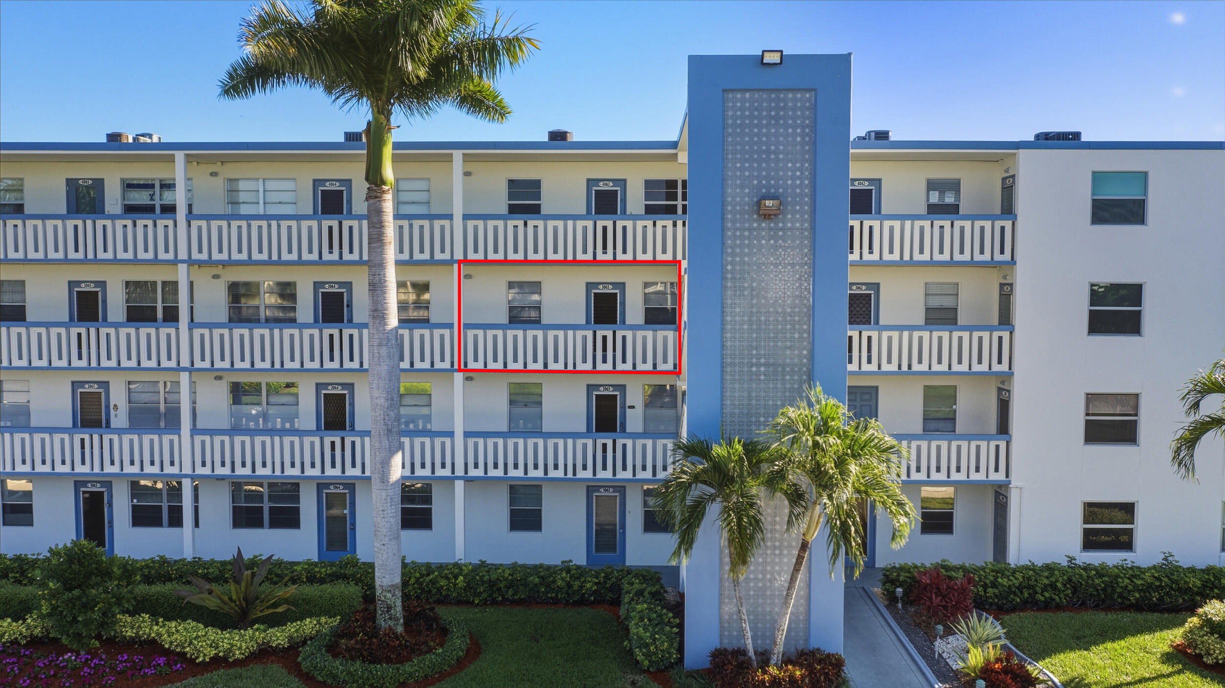 3063 Yarmouth C Boca Raton, FL 33434 - Photo 2 of 40 a front view of a building with a garden and plants