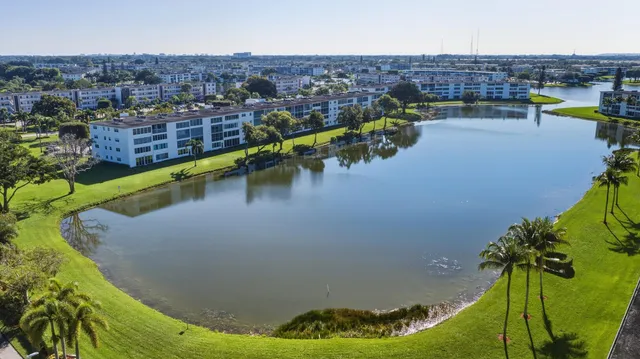 an aerial view of residential houses with outdoor space and swimming pool