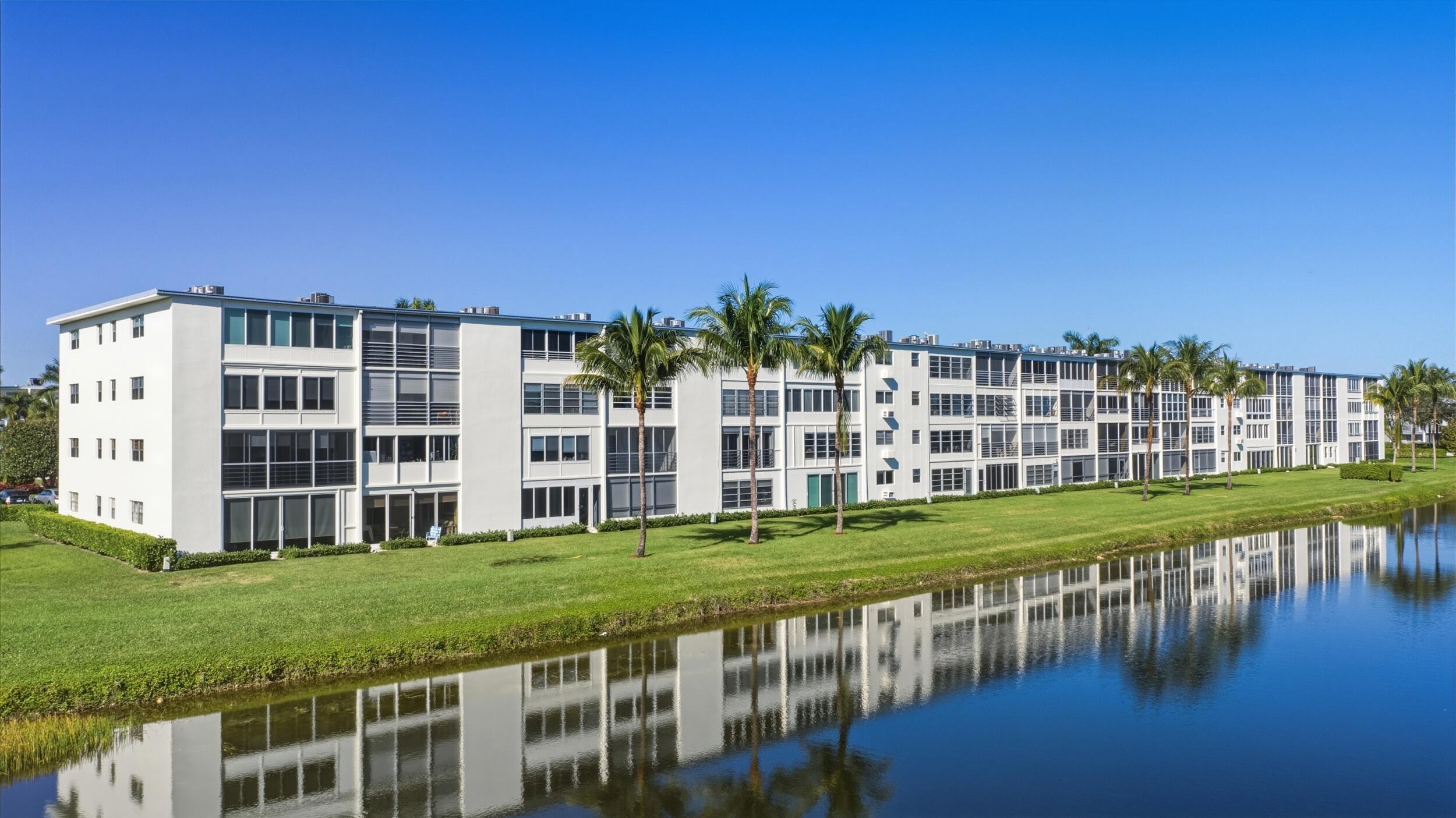 3063 Yarmouth C Boca Raton, FL 33434 - Photo 7 of 40 a view of building with garden and tall trees