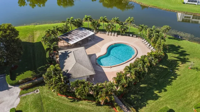 an aerial view of a house with a yard and swimming pool