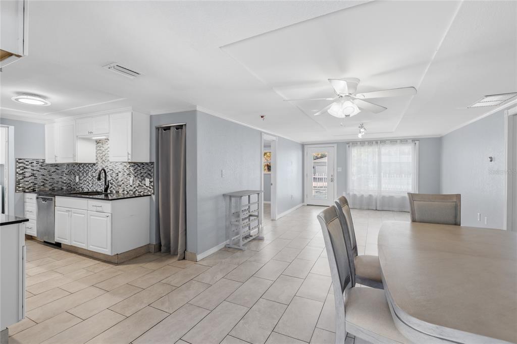 545 Bluebell Road Venice, FL 34293 - Photo 12 of 36 a large white kitchen with a large window and stainless steel appliances