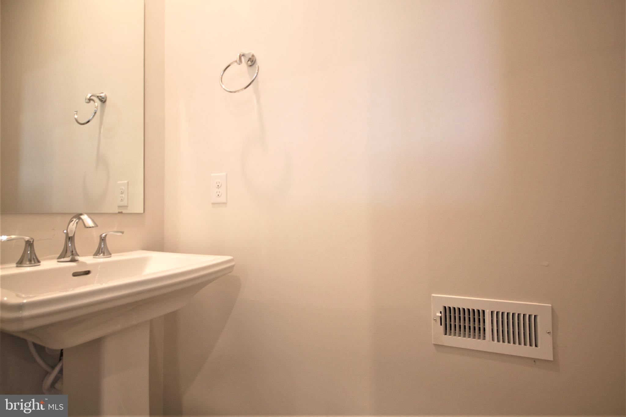 4856 Stump Road Pipersville, PA 18947 - Photo 15 of 35 a bathroom with a sink and a mirror