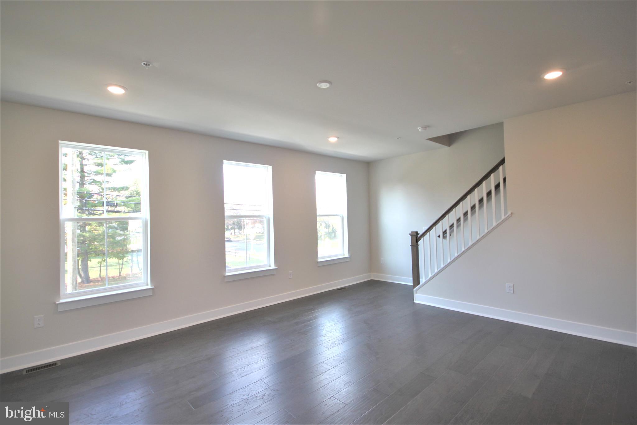 4856 Stump Road Pipersville, PA 18947 - Photo 7 of 35 a view of an empty room with wooden floor and a window