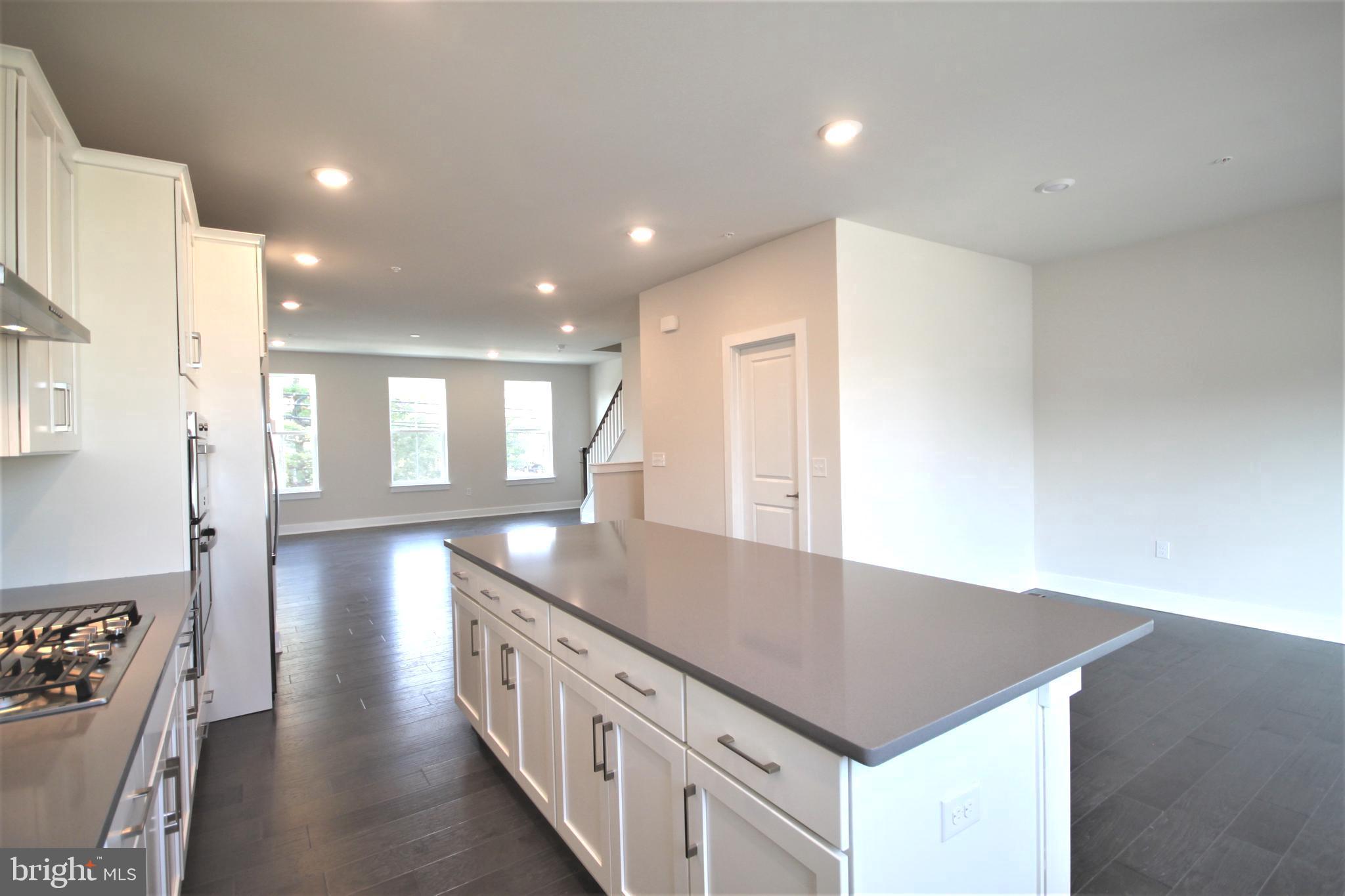 4856 Stump Road Pipersville, PA 18947 - Photo 10 of 35 a kitchen with stainless steel appliances granite countertop a sink a stove and a refrigerator