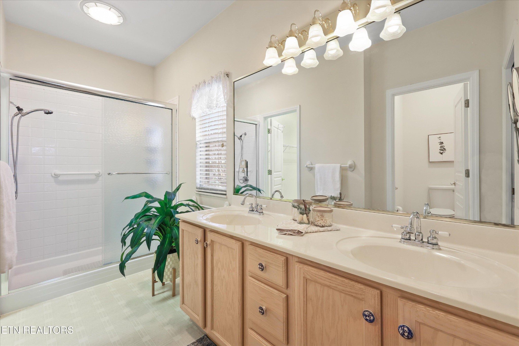 316 English Station Road Knoxville, TN 37934 - Photo 21 of 45 a bathroom with a double vanity sink and a mirror