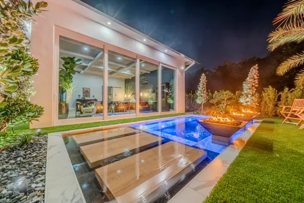 a view of a house with backyard and sitting area