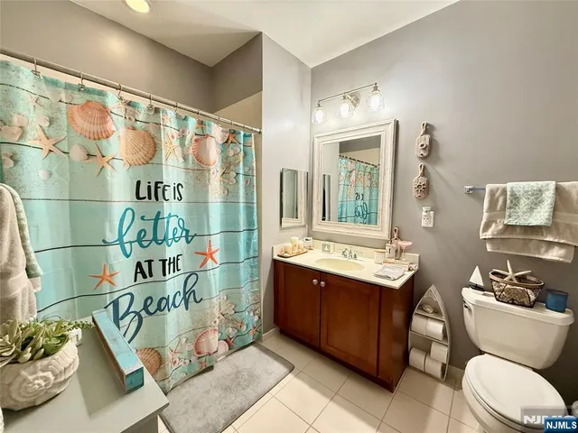 a bathroom with a sink mirror vanity and toilet