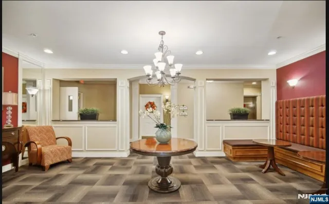 a living room with furniture and a chandelier