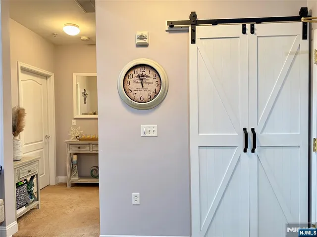 a view of hallway with stairs and a wooden floor