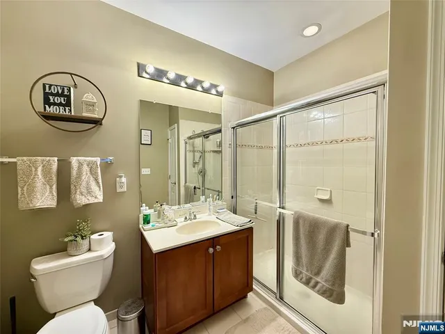 a bathroom with a double vanity sink mirror and toilet