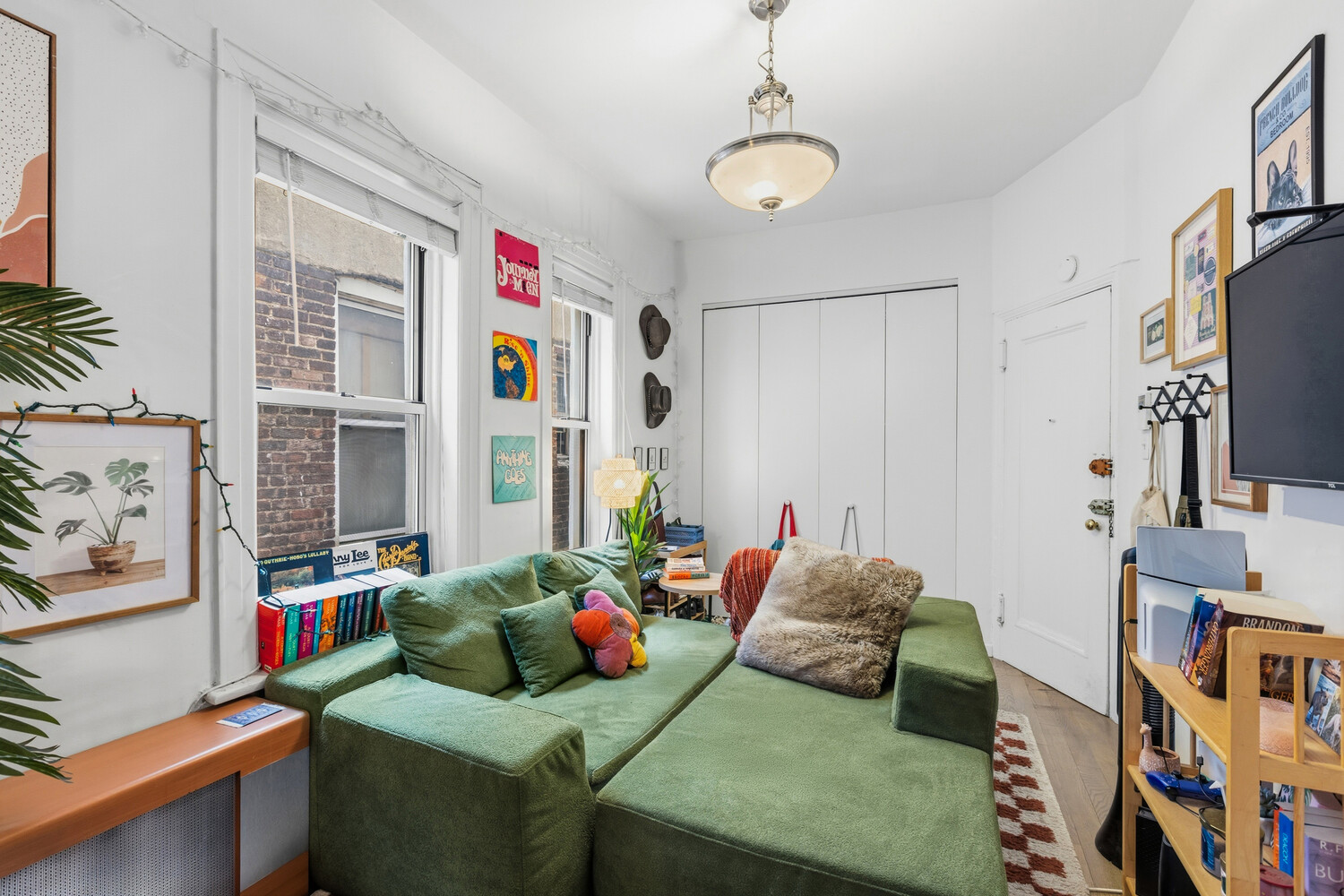 328 East 73rd Street, Unit 5B Manhattan, NY 10021 - Photo 1 of 10 a living room with furniture and a window