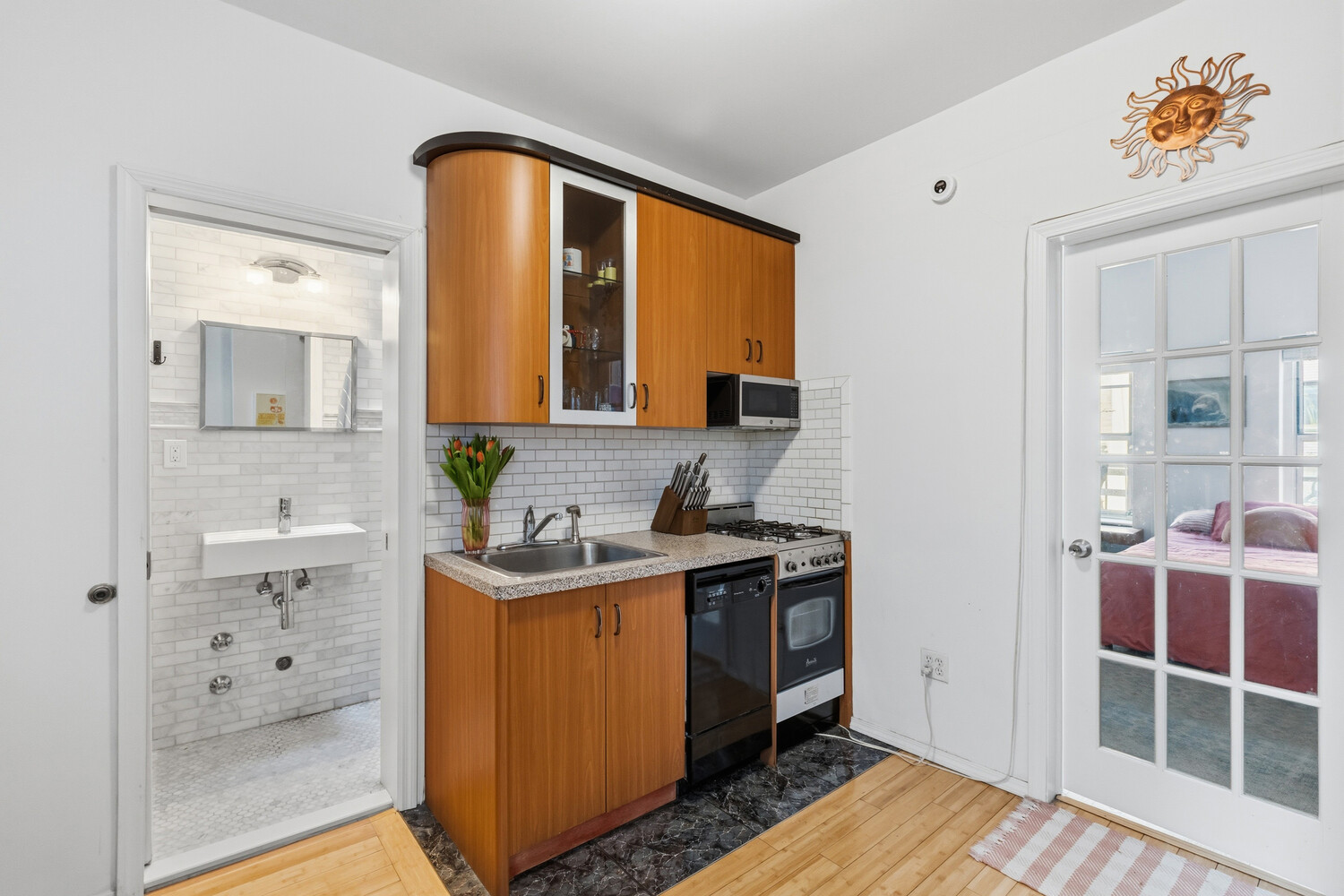 328 East 73rd Street, Unit 5B Manhattan, NY 10021 - Photo 4 of 10 a bathroom with a sink and a mirror
